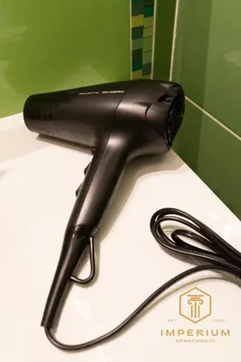 a black hair dryer sitting on top of a sink at Imperium Deluxe Apt - 300mt to Metro B, 3 bedrooms, Panoramic view, A-C in Rome