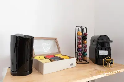 a desk with a computer and a box of wine at Imperium Deluxe Apt - 300mt to Metro B, 3 bedrooms, Panoramic view, A-C in Rome
