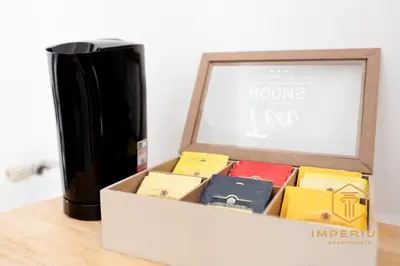 a box filled with different colored boxes next to a vase at Imperium Deluxe Apt - 300mt to Metro B, 3 bedrooms, Panoramic view, A-C in Rome