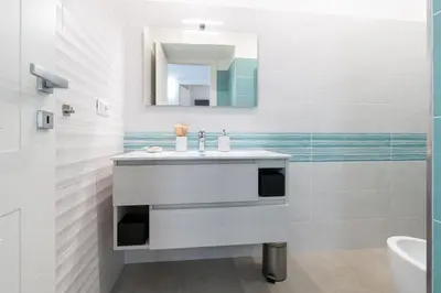 a bathroom with a sink and a mirror at Roma-Gemelli - Free Parking - Private Garden in Rome
