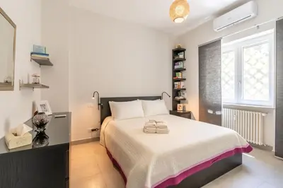 a bedroom with a bed with two towels on it at Roma-Gemelli - Free Parking - Private Garden in Rome