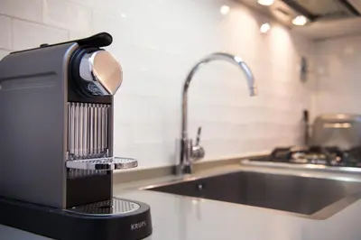 a kitchen with a mixer on a counter next to a sink at Casa Belsiana in Rome