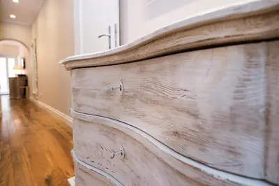 a wooden dresser in a room with a wooden floor at Casa Belsiana in Rome