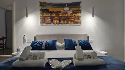 a bedroom with a bed with blue sheets and blue pillows at Vacanze Romane da Manuela in Rome