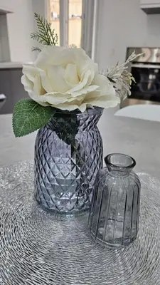 a vase with a flower in it on a table at Vacanze Romane da Manuela in Rome