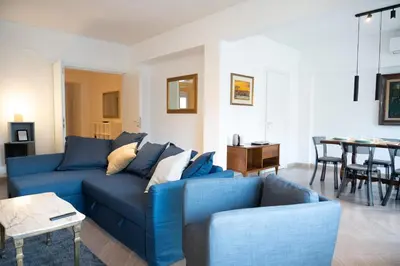 a living room with a blue couch and a table at Vatican Fiore apartment in Rome