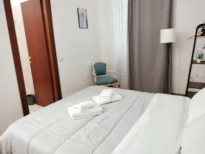 a white bed with two towels on top of it at The Stay in Rome