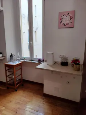 a kitchen with a counter and a window and a table at The Stay in Rome