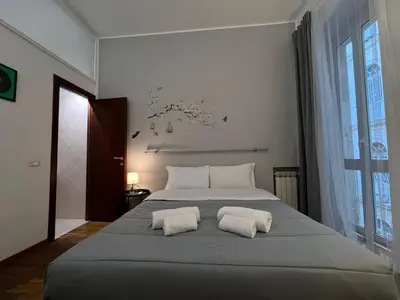 a bedroom with a large bed with two white pillows at The Stay in Rome