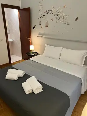 a bedroom with a large bed with two towels on it at The Stay in Rome