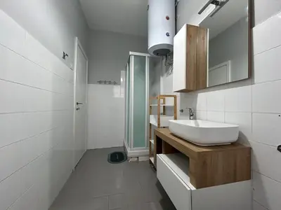 a white bathroom with a sink and a shower at 5Piano Ascensore Near Vaticano Ideale per Famiglie in Rome