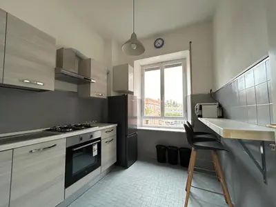 a kitchen with a stove and a sink and a window at 5Piano Ascensore Near Vaticano Ideale per Famiglie in Rome
