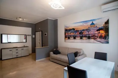 a living room with a couch and a painting on the wall at Appartamento a 2 passi da San Pietro in Rome