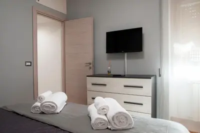 a bedroom with a bed with towels and a tv at Appartamento a 2 passi da San Pietro in Rome