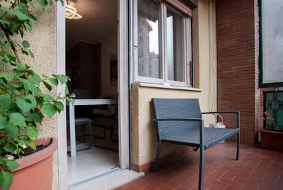 a chair sitting on a porch next to a window at Appartamento a 2 passi da San Pietro in Rome