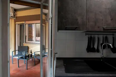 a kitchen with a sink and a table in a room at Appartamento a 2 passi da San Pietro in Rome