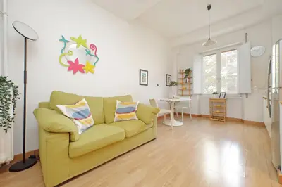 a living room with a yellow couch and a table at San Pietros Flat by DomusDimore in Rome