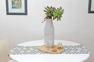 a vase on a table with a plant in it at San Pietros Flat by DomusDimore in Rome