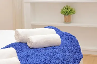a pile of towels sitting on top of a couch at San Pietros Flat by DomusDimore in Rome