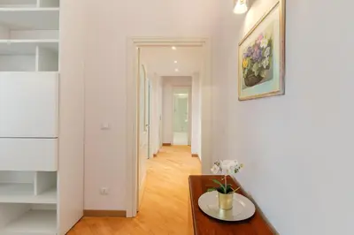 a living room with a table and a hallway at Contemporary Flat in Trastevere in Rome