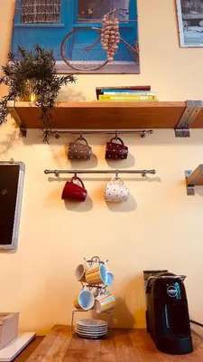 a wall with a shelf with pots and pans at Pamphili Apartment in Rome