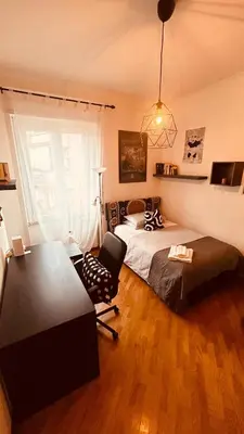 a bedroom with a bed and a chair and a desk at Pamphili Apartment in Rome