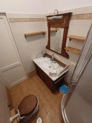 a bathroom with a sink and a mirror and a toilet at Pamphili Apartment in Rome