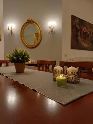 a table with two candles and a mirror at Pamphili Apartment in Rome