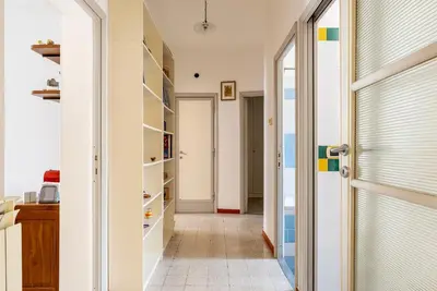 a hallway with a door to a room with shelves at GuestHost - Bright and roomy apartment in Flaminio district in Rome