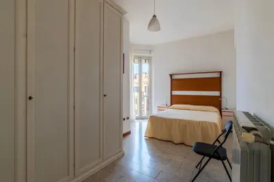 a bedroom with a bed and a desk and a chair at GuestHost - Bright and roomy apartment in Flaminio district in Rome