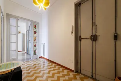 a hallway with a door and a table in a room at GuestHost - Bright and roomy apartment in Flaminio district in Rome