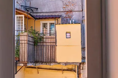 a view of a yellow building from a window at iFlat Charming Vintage Apartment in Esquilino in Rome