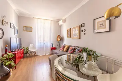 a living room with a couch and a table at iFlat Charming Vintage Apartment in Esquilino in Rome