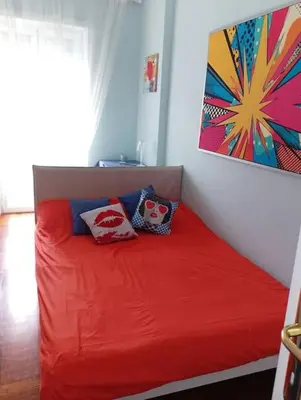 a red couch with two pillows on it in a room at Cin Cin ROMA Centro in Rome