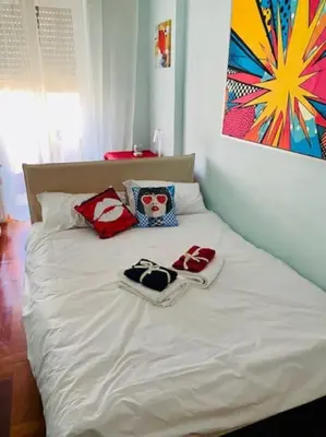 a white bed with towels and shoes on it at Cin Cin ROMA Centro in Rome