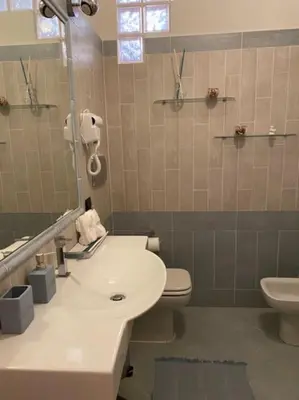 a bathroom with a sink and a toilet at Cin Cin ROMA Centro in Rome