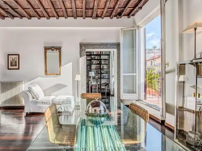a living room with a glass table and a couch at Luxury Spanish Steps Terrace in Rome