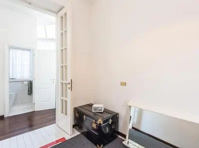 a room with a suitcase sitting next to a door at Luxury Spanish Steps Terrace in Rome