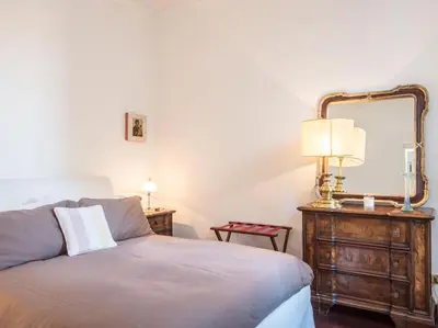 a bedroom with a bed with a mirror and a dresser at Luxury Spanish Steps Terrace in Rome
