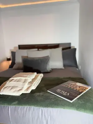 a book sitting on top of a bed at La Dimora a Roma antica in Rome