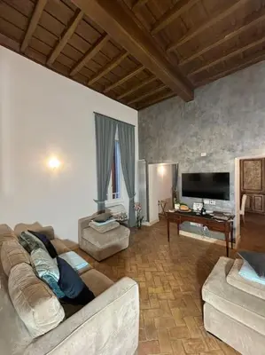 a living room with a couch and a tv at La Dimora a Roma antica in Rome