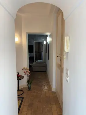a hallway with a hallway leading to a living room at La Dimora a Roma antica in Rome