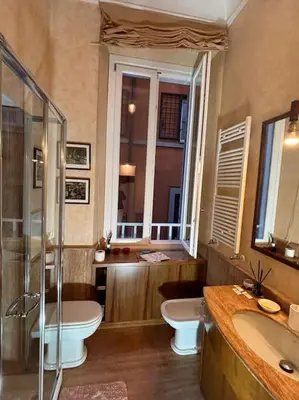 a bathroom with two sinks and a tub and a toilet at La Dimora a Roma antica in Rome