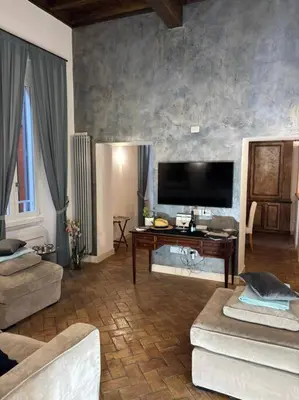 a living room with a couch and a tv at La Dimora a Roma antica in Rome