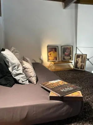 a book sitting on top of a bed at La Dimora a Roma antica in Rome