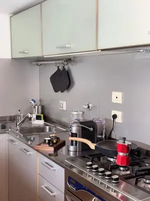 a kitchen with a sink and a stove top at La Dimora a Roma antica in Rome