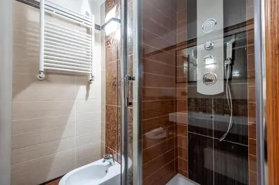 a bathroom with a shower and a toilet and a sink at Elegantis Purificazione Suite Apartment in Rome