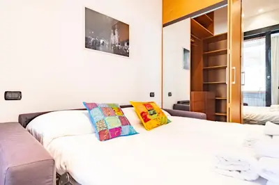 a bedroom with a white bed with two pillows at Elegantis Purificazione Suite Apartment in Rome