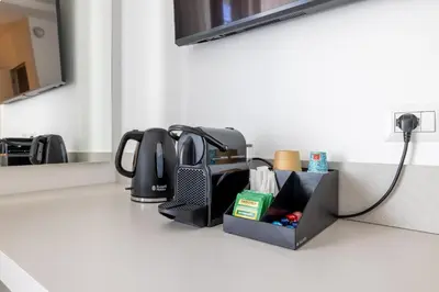 a kitchen counter topped with a sink with at Hezio Guest House in Rome