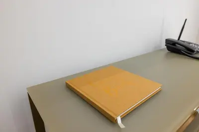 a notebook sitting on a table with a phone at Hezio Guest House in Rome